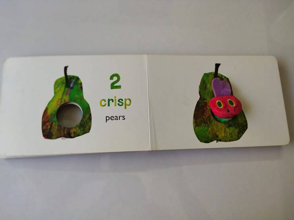 Hungry caterpillar eating two pears.